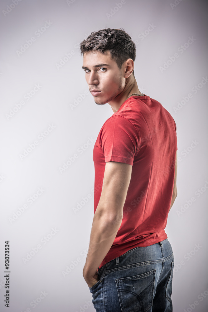 Serious young man looking at camera on light background Serious young man looking at camera on light background