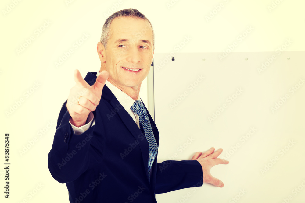 Male executive with marker pointing on someone Male executive with marker pointing on someone
