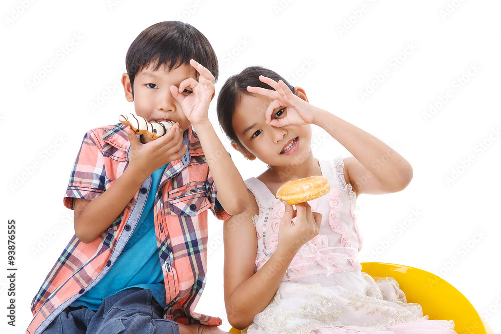 Two kids looking through their ok finger with donuts Two kids looking through their ok finger with donuts