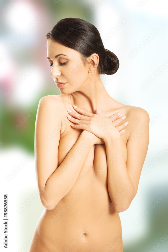 Fototapeta premium Nude woman crossing her arms on chest