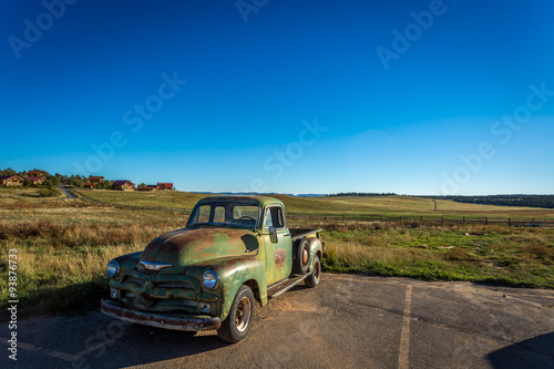 Fototapeta Naklejka Na Ścianę i Meble -  Classic Old Car decays in a meadow. 