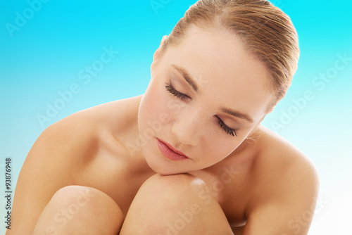Spa woman sitting on the floor.