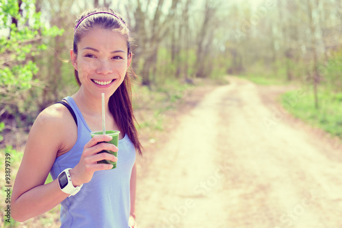 Smartwatch girl drinking healthy green smoothie