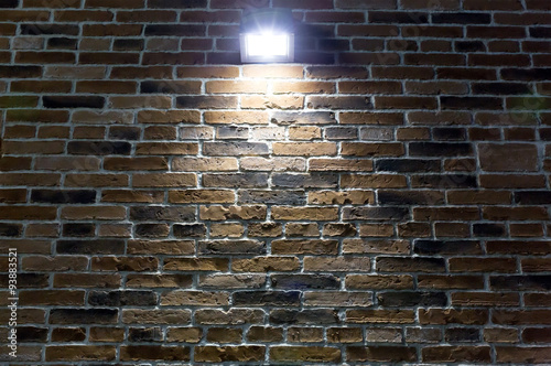 spotlight on red brick wall at night