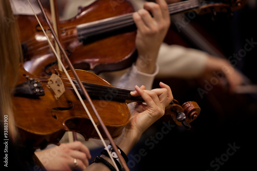 The hands of violinists in a Symphony orchestra