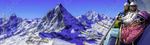 Ski, skiing in Zermatt, Switzerland - skiers on ski lift with view of Matterhorn