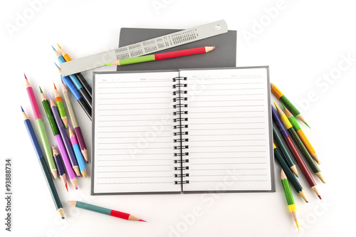 Notebook and paintbrush isolated on white background