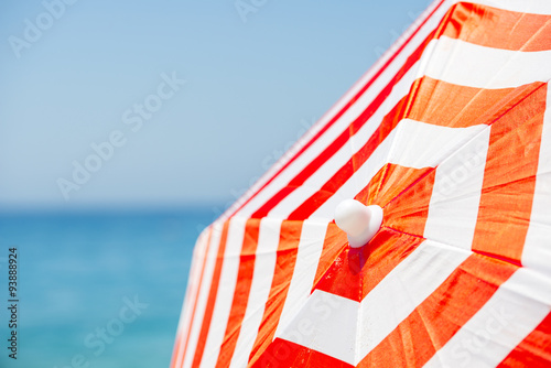 Striped beach umbrella on the beach.