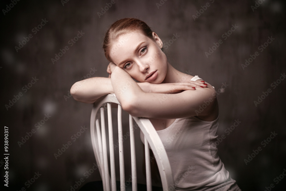  beautiful woman sitting on a white chair