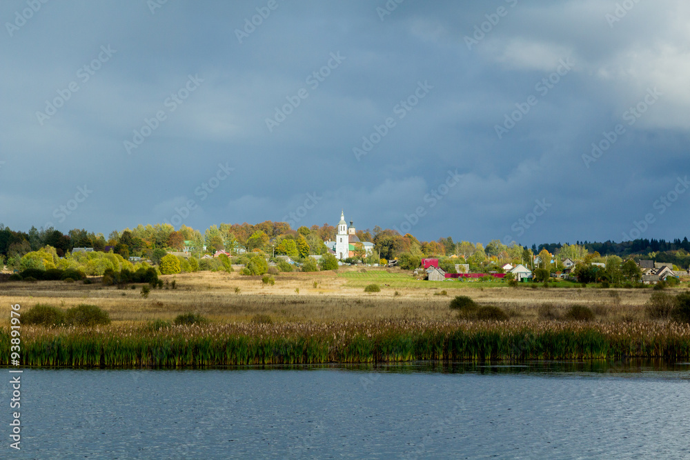 Landscape with a lake and church and village.