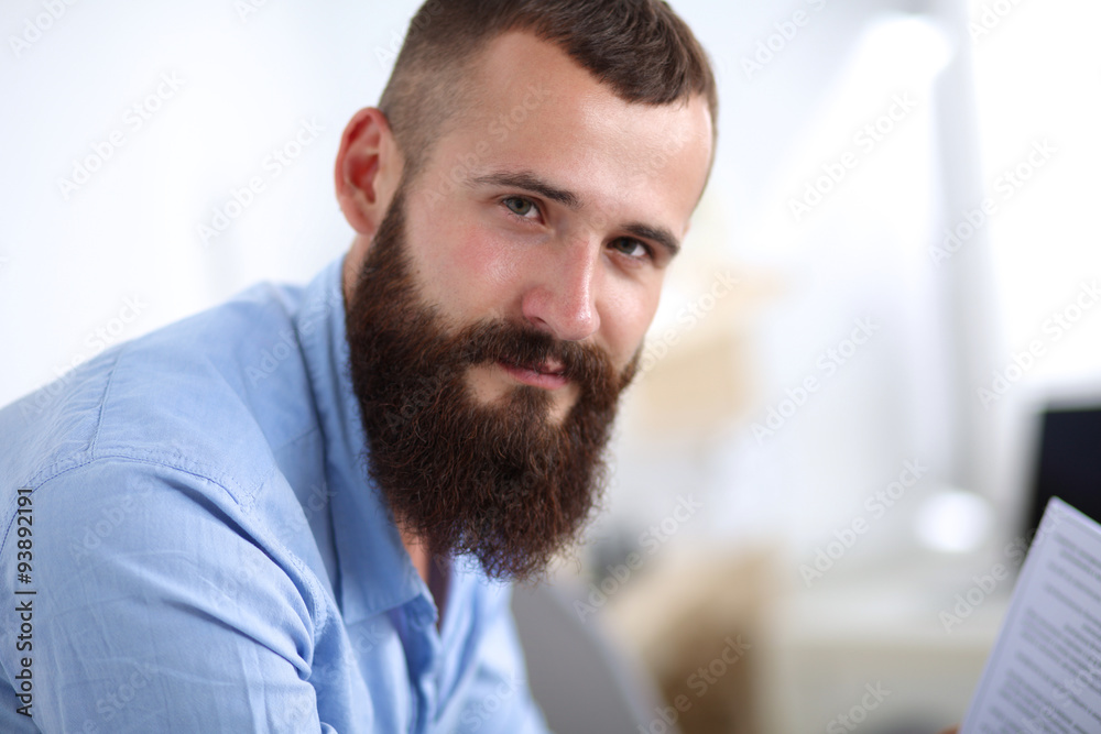 Young businessman sitting on chair in office Young businessman sitting on chair in office