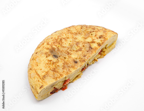 Spanish omelette with olive oil and red pepper isolated on white