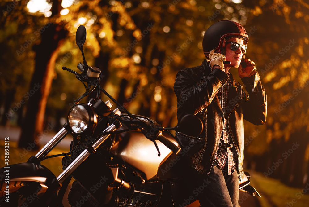 Fototapeta premium Motorcyclist with a cafe-racer motorcycle outdoors