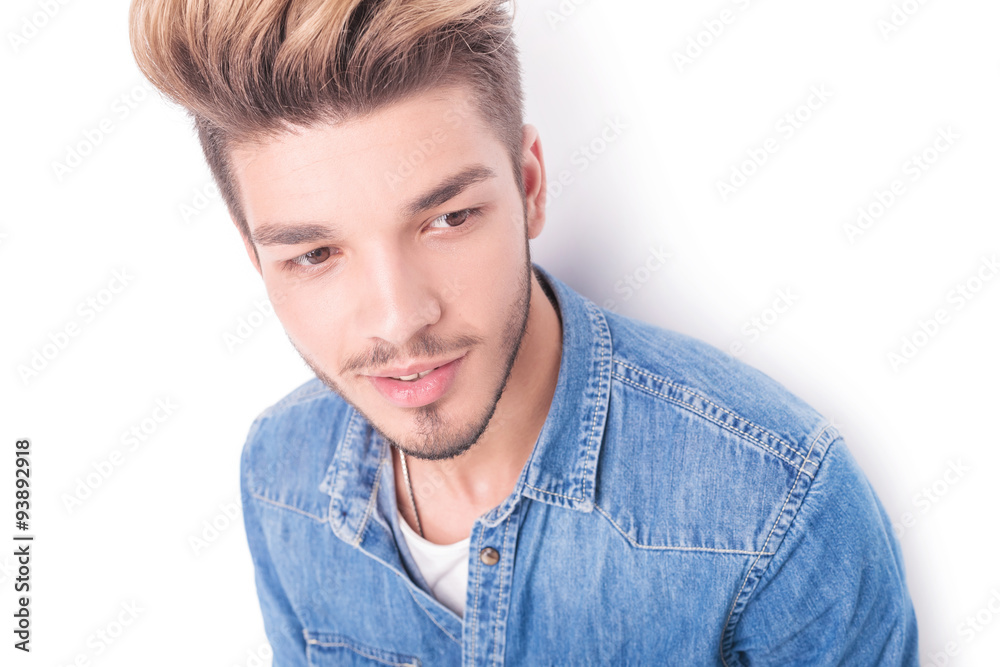 face of a young casual man smiling looking to side face of a young casual man smiling looking to side