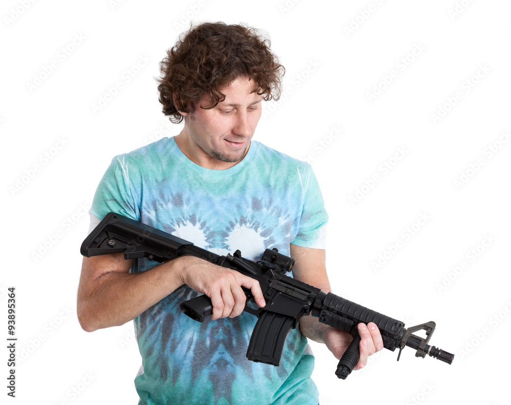 Adult man holding machine gun in hands and looking at weapon, isolated on white background Adult man holding machine gun in hands and looking at weapon, isolated on white background