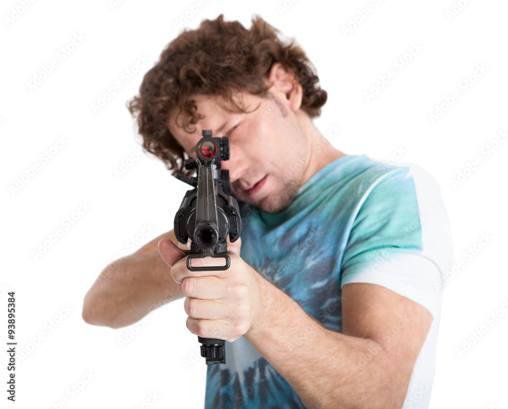 Caucasian man taking aim with a machine gun, isolated on white background Caucasian man taking aim with a machine gun, isolated on white background