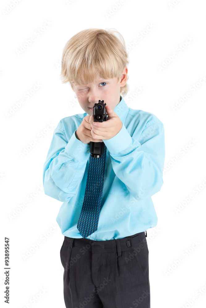 Caucasian blond boy aiming with black gun in hands, isolated on white background Caucasian blond boy aiming with black gun in hands, isolated on white background
