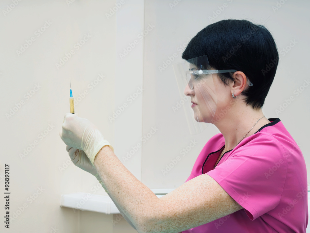Doctor holding syringe with blood at laboratory Doctor holding syringe with blood at laboratory