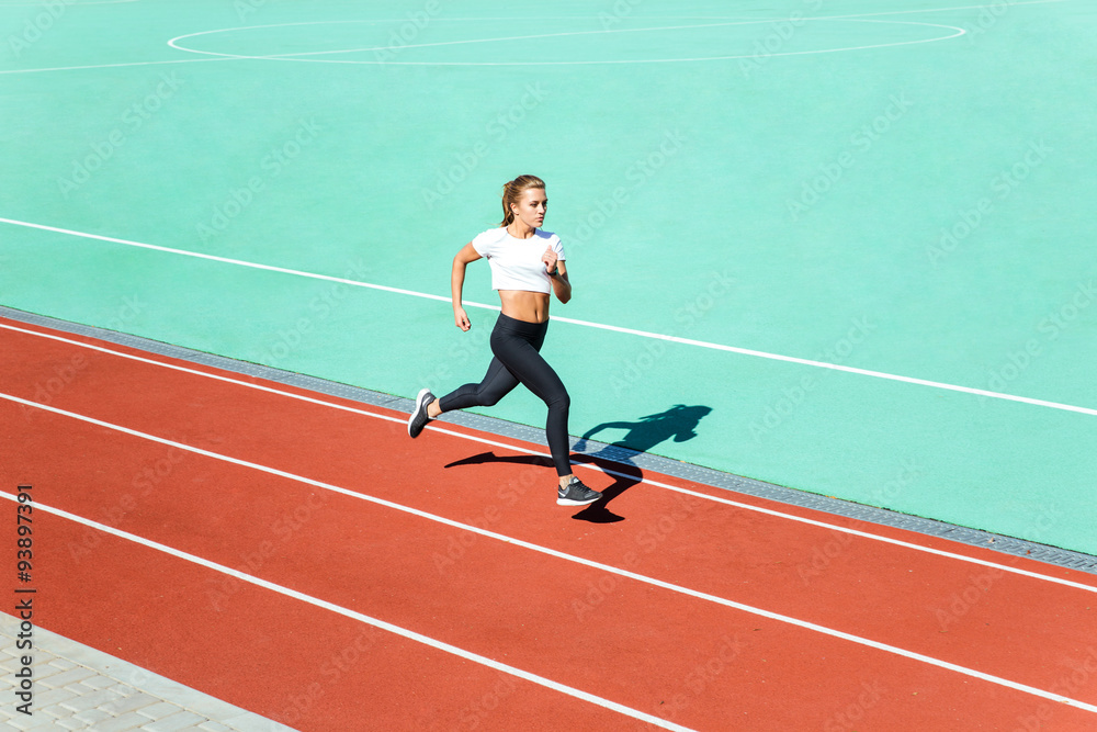 Female jogger running at stadium Female jogger running at stadium