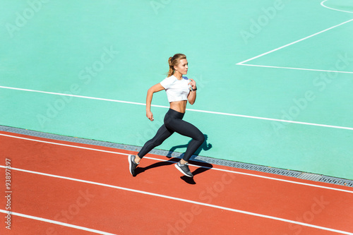 Fitness woman running at stadium © Drobot Dean