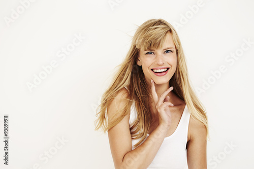 Happy young blond woman in studio