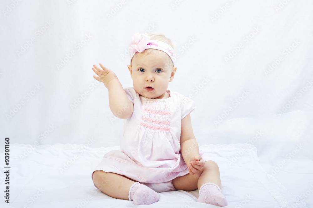 baby girl playing in the white studio surroundings baby girl playing in the white studio surroundings