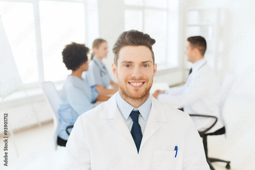 happy doctor over group of medics at hospital