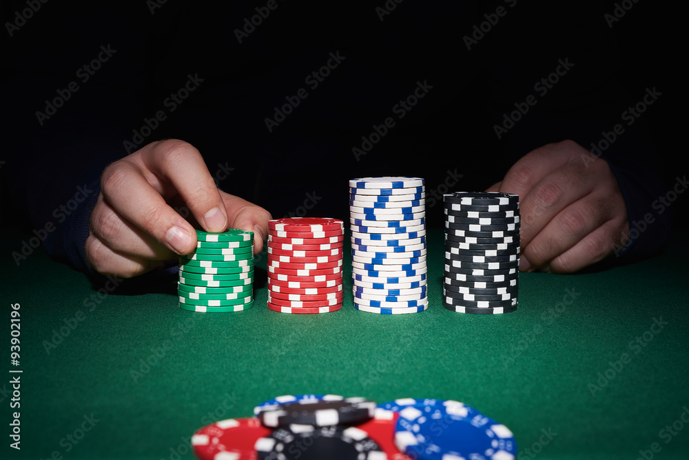 Poker chips on table with hands Poker chips on table with hands