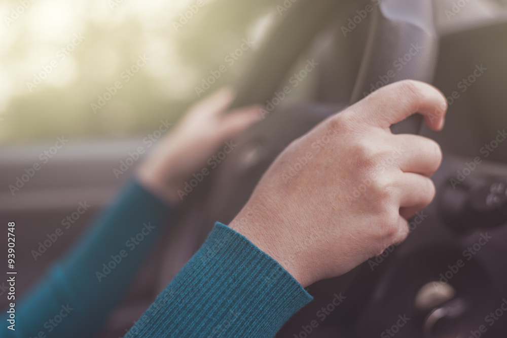Safe driving, woman grips car steering wheel