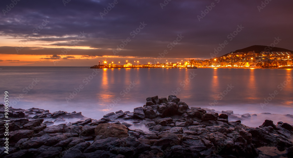 Obraz premium Beautiful lava seashore near the city of Arona in Tenerife during sunset.