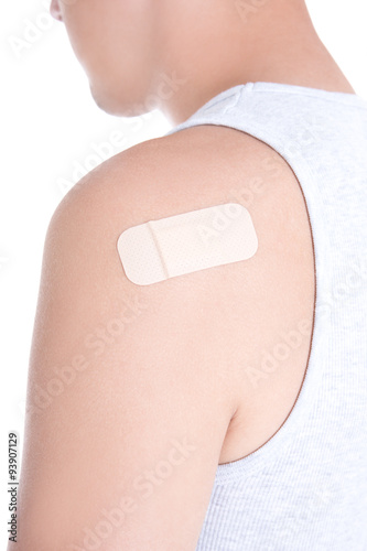 medical adhesive plaster on male shoulder isolated on white
