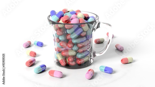 Transparent coffee mug full of pills,isolated on white background.