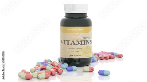 Obraz na plátne Colorful caplets vitamins and bottle, isolated on white background