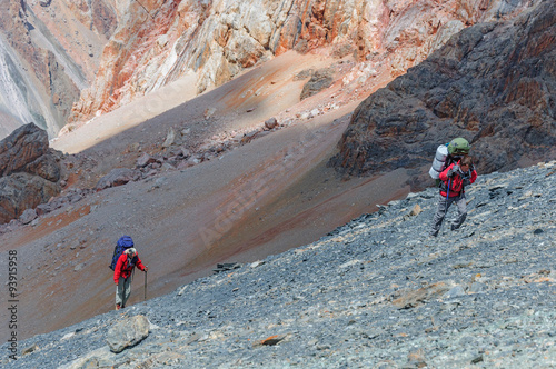 Two men climbing on the top.
