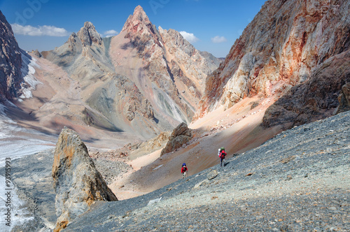 Two men climbing on the top.