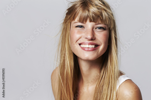 Lovely young woman smiling in studio