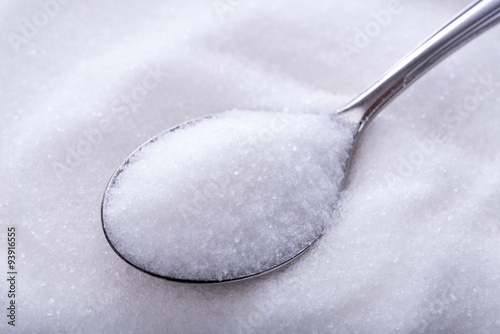 Spoonfuls of crystal white sugar