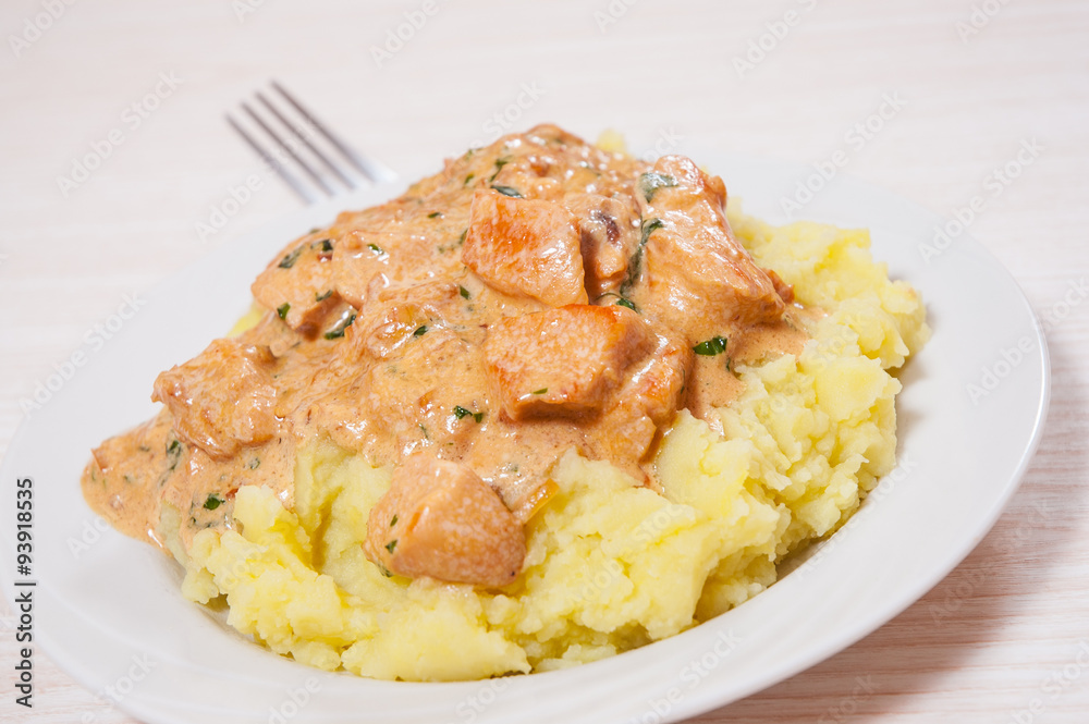 chicken breast in a creamy sauce with mashed potatoes