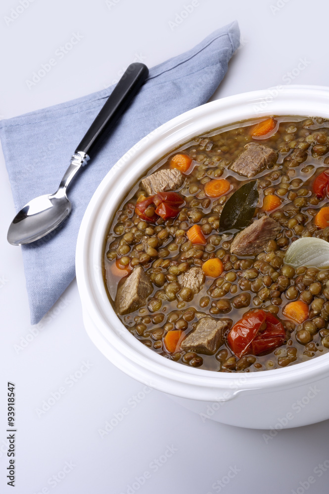 Pot of lentils with meat and white background Pot of lentils with meat and white background