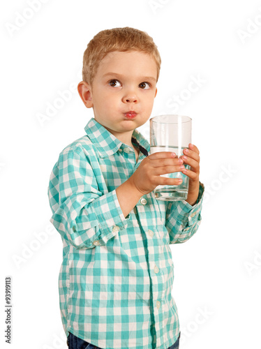 Boy in plaid shirt holding a transparent glass.