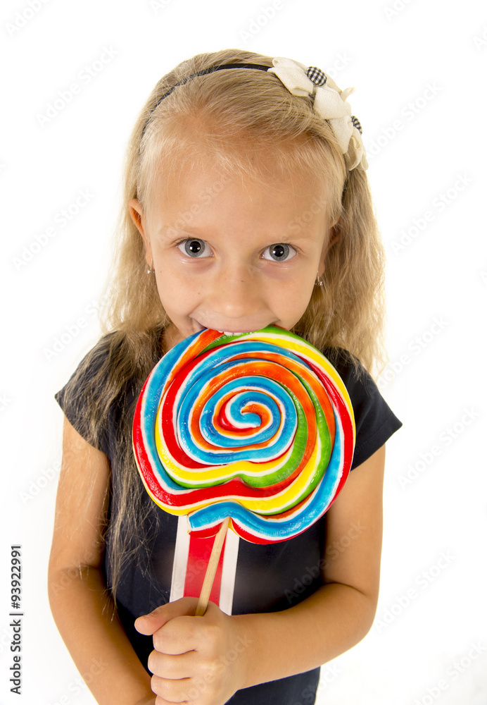 beautiful little female child with sweet blue eyes eating huge lollipop spiral candy smiling happy