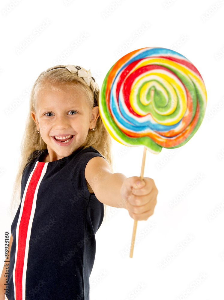 beautiful little female child with sweet blue eyes holding huge lollipop spiral candy smiling happy