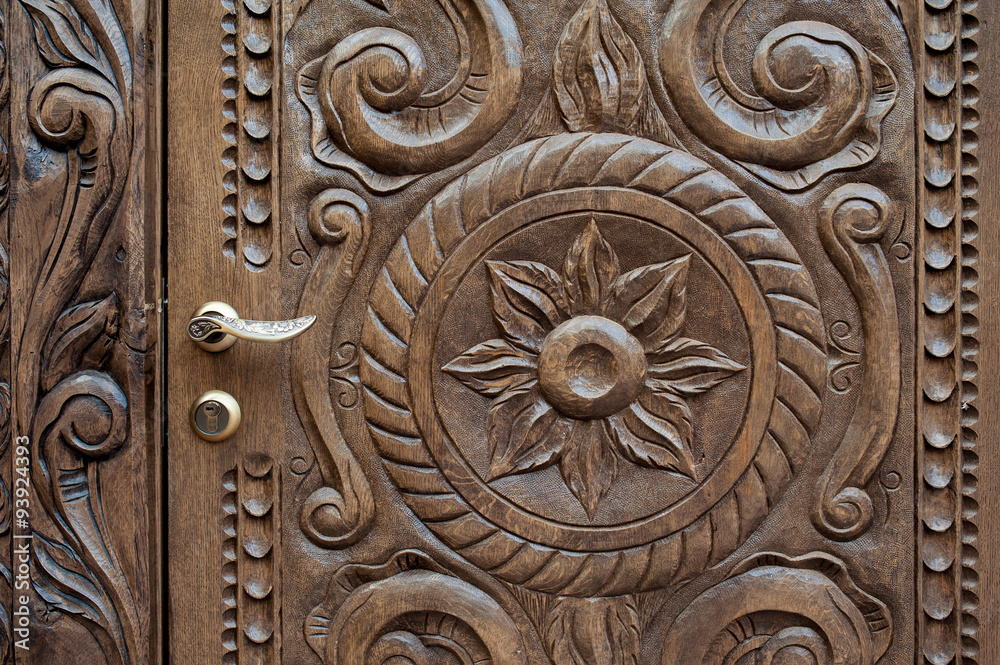 beautiful ornately carved wooden panel in an antique door