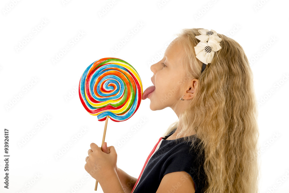 beautiful female child with long blond hair eating licking huge spiral lollipop candy