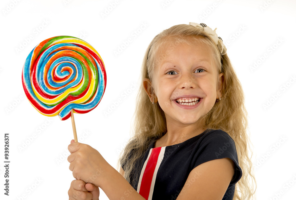 beautiful female child with long blond hair holding huge spiral lollipop candy smiling happy