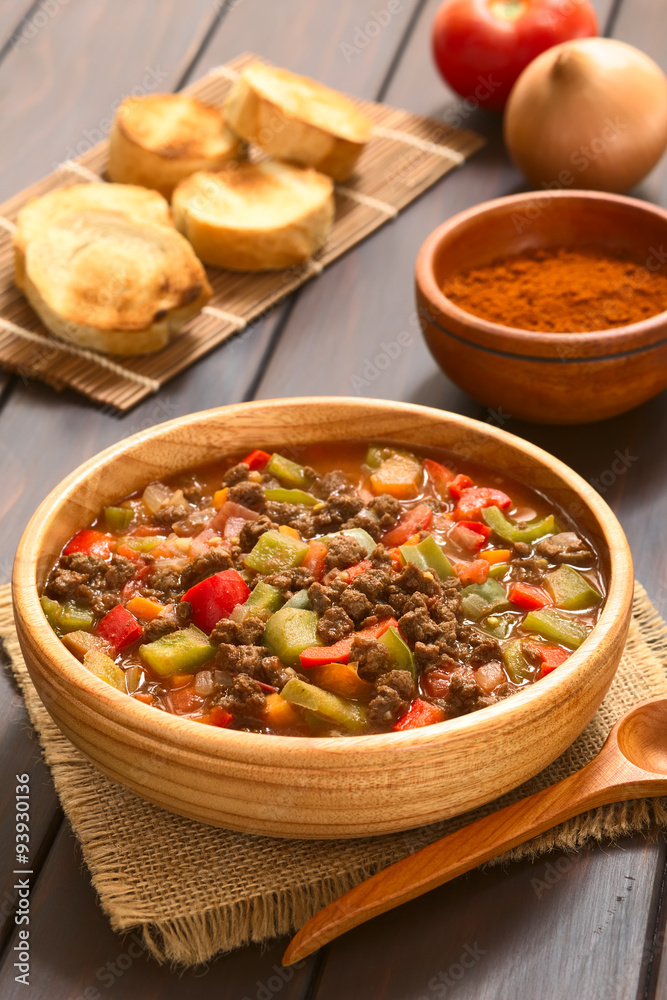Vegan goulash made of soy meat (textured vegetable protein), capsicum, tomato and onion, photographed with natural light (Selective Focus, Focus one third into the dish) Vegan goulash made of soy meat (textured vegetable protein), capsicum, tomato and onion, photographed with natural light (Selective Focus, Focus one third into the dish)