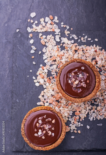 Homemade tarts of shortcrust pastry with dark chocolate and a pink sea salt