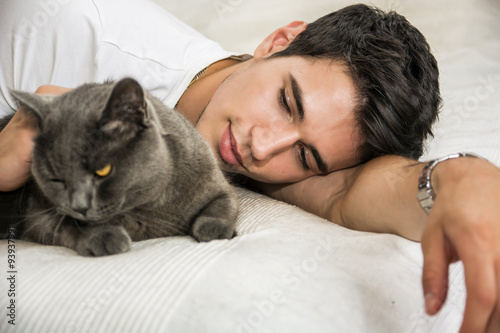 Handsome Young Man Cuddling his Gray Cat Pet