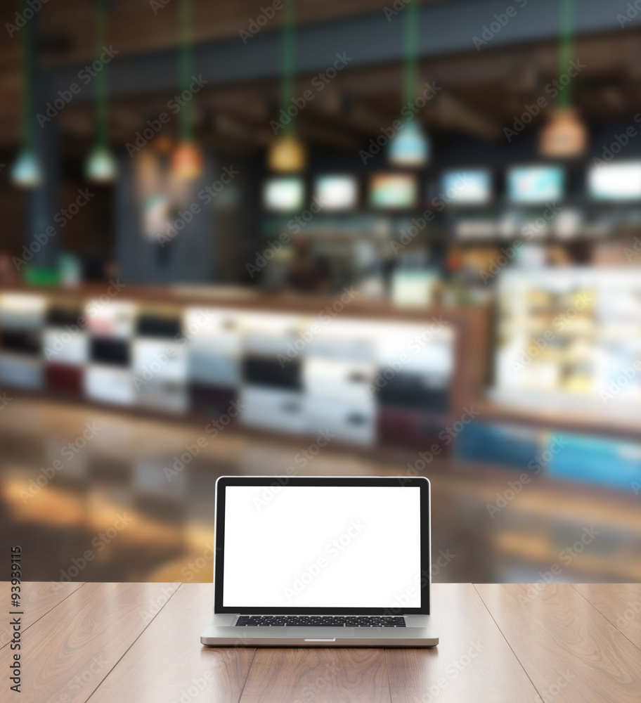 Blank screen laptop computer with blur coffee shop background