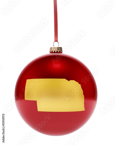 Red bauble with the golden shape of Nebraska.(series) photo